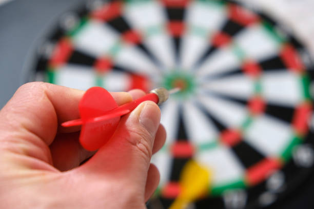 istock a hand throws darts on a dartboard, a hand holding a dart, a colorful dart and a dartboard, 1291046832