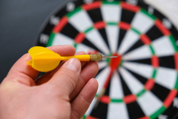 istock a hand throws darts on a dartboard, a hand holding a dart, a colorful dart and a dartboard, 1291046996