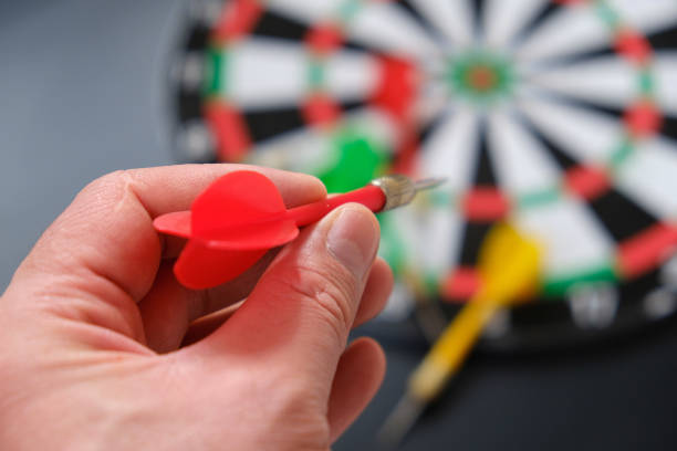 istock a hand throws darts on a dartboard, a hand holding a dart, a colorful dart and a dartboard, 1291047002