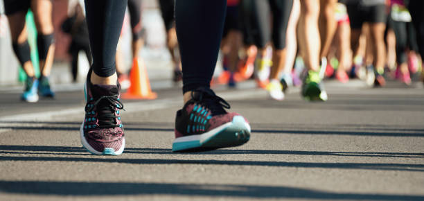 istock Marathon running race, runners feet on road 1291048210
