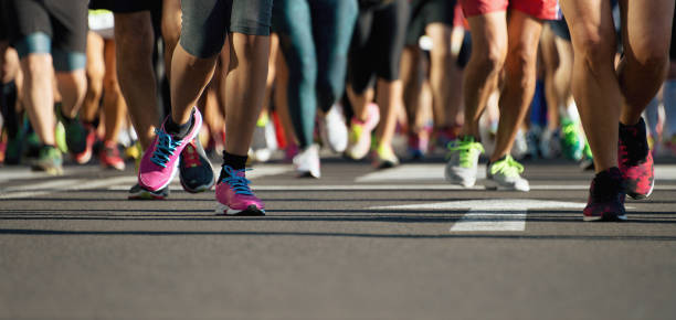 istock Marathon running race, runners feet on road 1291048216