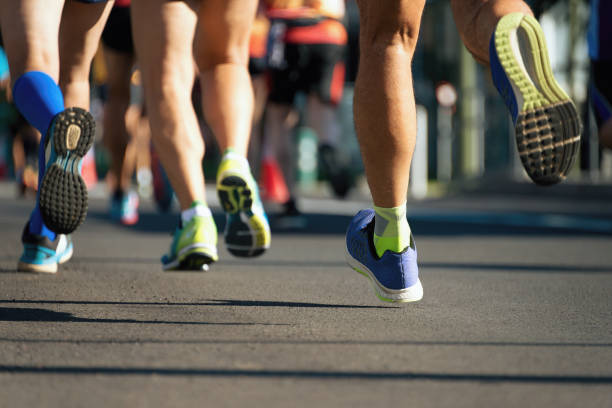 istock Marathon running race, runners feet on road 1291048226