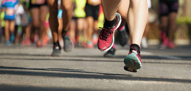 istock Marathon running race, runners feet on road 1291048757