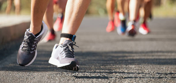 istock Marathon running race, runners feet on road 1291048779