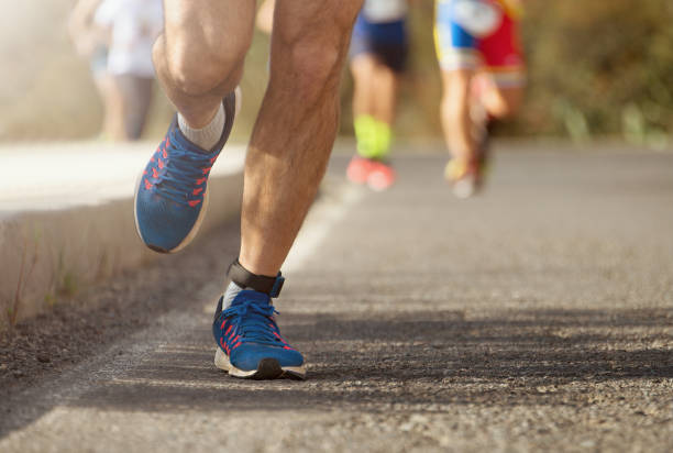istock Marathon running race, runners feet on road 1291048794