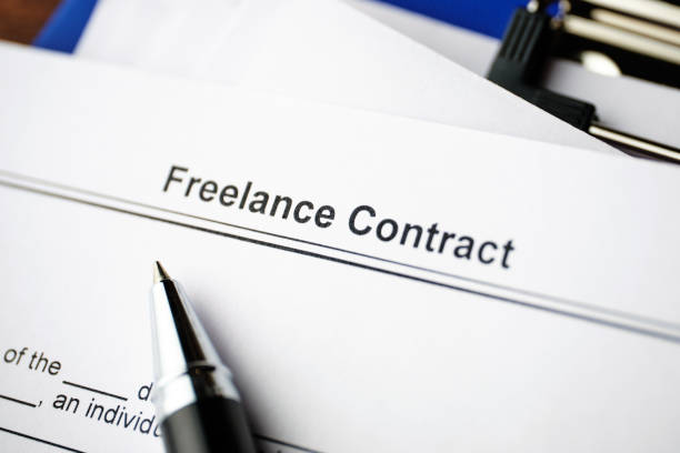 istock Legal document Freelance Contract on paper close up 1291049119