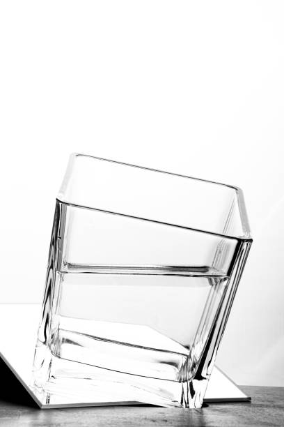 Half-full Glas high key cubic Glas half-filled and leveled angular in high key cuboidal epithelium stock pictures, royalty-free photos & images