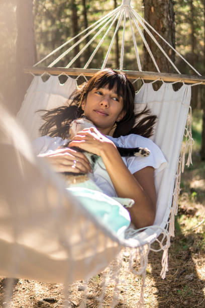 istock Hammock, pet and lady in woods 1291050405