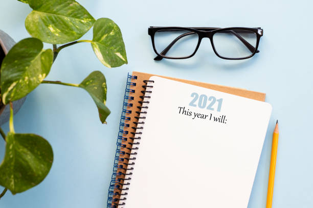 istock 2021 new year notebook ready to write goals in it, on a blue background 1291052686