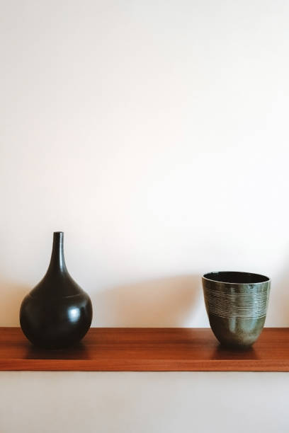 istock Two ceramic vases on a wooden shelf. 1291052906