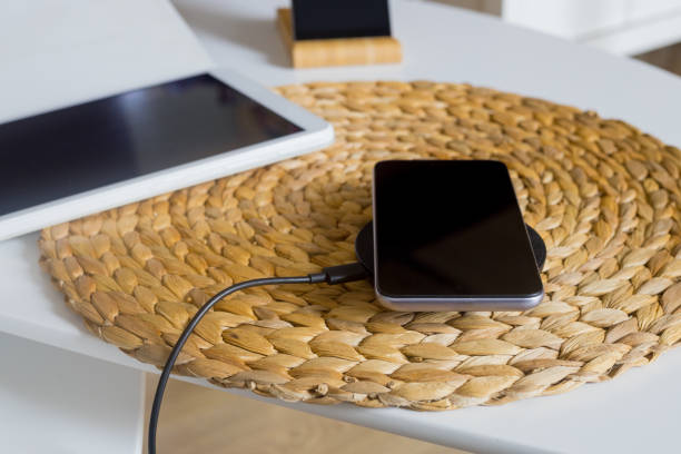 istock the phone lying on the wireless charger next to the tablet 1291053686