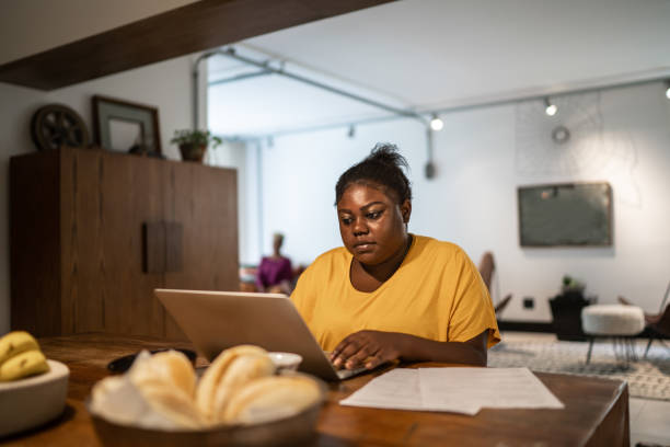 istock Young woman working at home, using laptop 1291053811