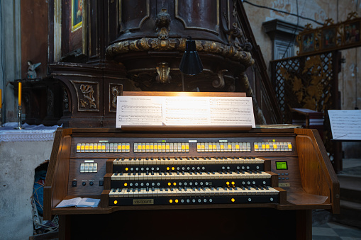 Komarno, Ukraine - October 8, 2020:  Interior of Roman Catholic Church of Nativity of the Blessed Virgin Mary in Komarno, Lviv region, Ukraine. Modern organ console