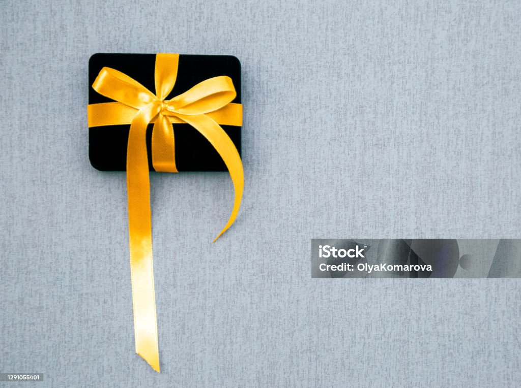 Copy Rime Box Black Box With Yellow Ribbon On A Gray Background Copy Space Stock ...