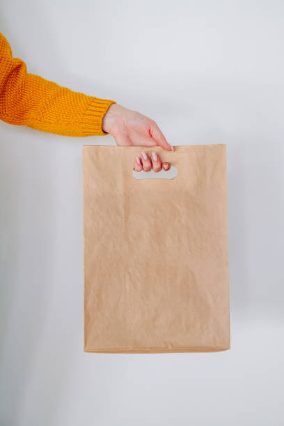istock delivery hand with paper shopping bag 1291055679