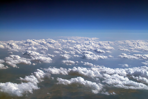 Photograph made of the sky from the window of a commercial airplane.