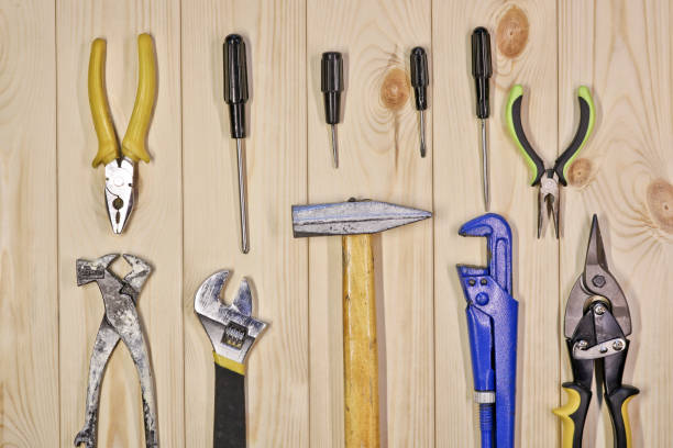 istock A set of assorted work carpentry and locksmith tools on a light wooden background with copy space. 1291060219