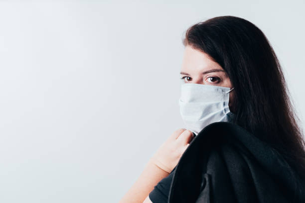 istock Woman posing in protective face mask 1291062913