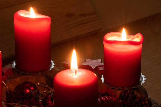istock Red burning candles on an Advent arrangement. It is the third Advent. Christmas is coming soon. 1291062984