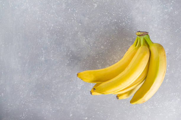 Tasty yellow banana on grey concrete background top view https://esp.gettyimages.com/app/?batch_tag_filters_and=&batch_tag_filters_exclude=&batch_tag_filters_or=&boolean_filters=&date_from=2017-01-29&date_to=2020-12-14&event_or_brief_ids=&iptc_category_filters=&page=1&page_size=10&profile_tag_filters_and=&profi