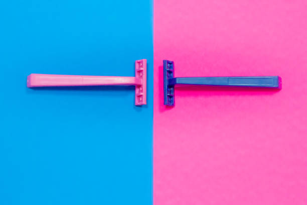 Pink razor on a blue background and blue razor on a pink background. Concept of sexual diversity, no gender and no discrimination. stock photo