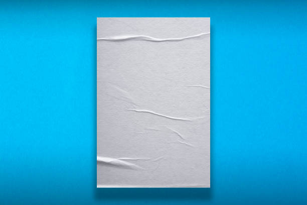 istock Sheet of crumpled white paper on blue background. 1291065453
