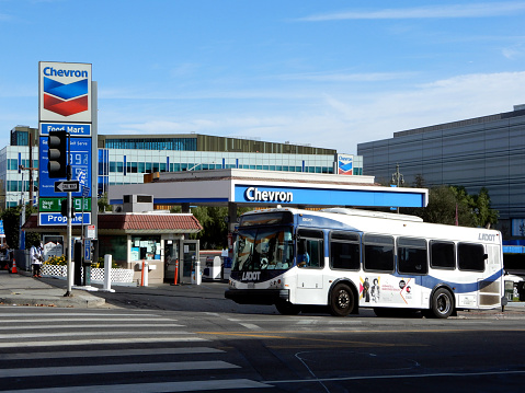 Los Angeles, California, USA - December 13, 2020: Los Angeles DASH Bus and Chevron Gas Station.