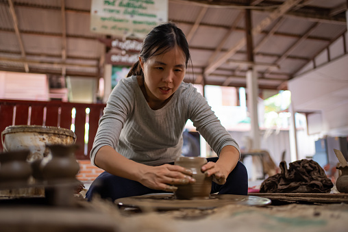 Young woman artist in ceramic workshop. Professional Occupation