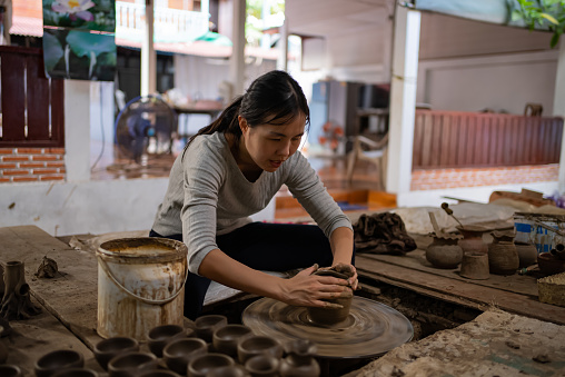 Young woman artist in ceramic workshop. Professional Occupation