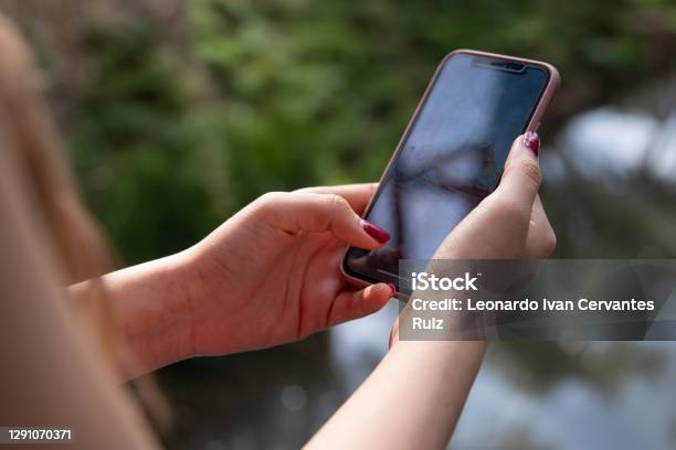 Closeup Of A Young Woman Using Mobile Phone Stock Photo - Download Image Now - Adult, Adults Only, Apartment
