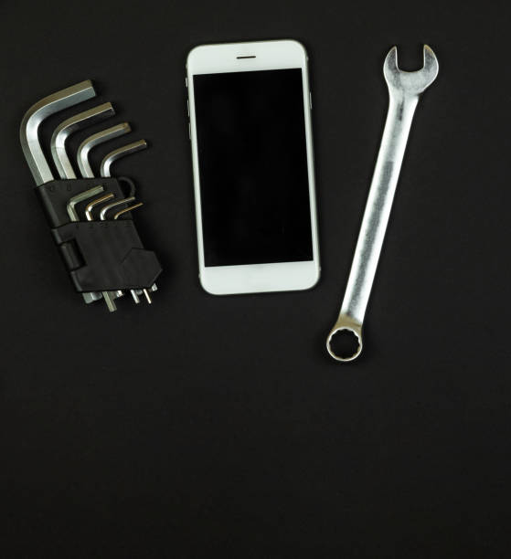 istock Working square concept, a set of tools and a smartphone on a black background, flat lay, copy space, top view 1291072153