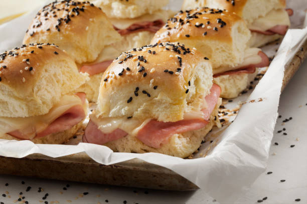 istock Baked Ham And Swiss Sliders on White Dinner Buns 1291073031
