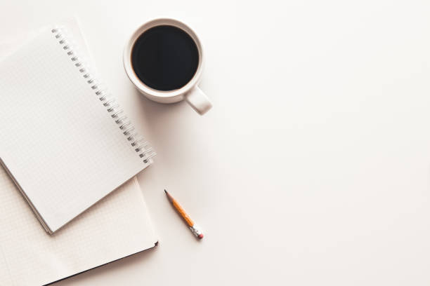 istock Office desk table with supplies, coffee cup and flower. Top view 1291076654