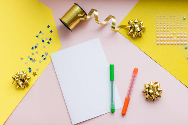 istock accessories for holidays. Stylish paper, scissors, thread on colorful table, copy space. Seasons greeting card mockup.Blank paper card.Hand made greeting card,present. DIY. Christmas celebrating stuff 1291076866