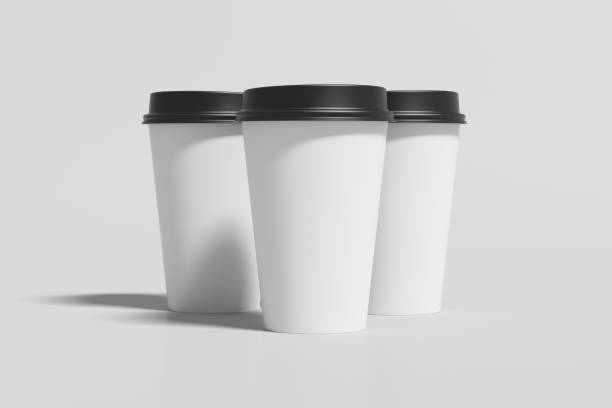 istock Three white take away coffee paper cups mock up with black lids on white background. 1291078844