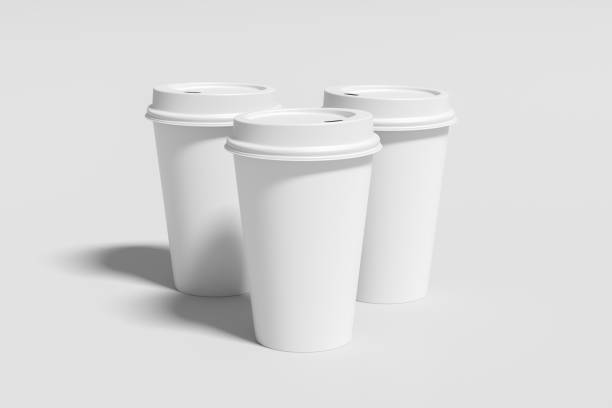istock Three white take away coffee paper cups mock up with white lids on white background. 1291078905
