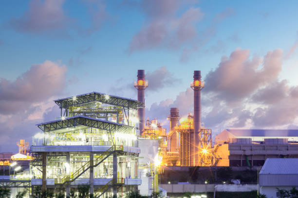 Industrail plant with sky background. Gas fired power plant and factory building at night. Also called gas fired power station or natural gas power plant. That technology to burn natural gas and generate electricity or electrical energy. natural gas extraction stock pictures, royalty-free photos & images