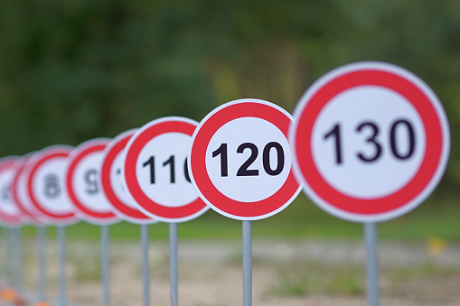 Germany, Berlin, January 17, 2024 - Speed limit traffic sign against trees and sky, Berlin Zehlendorf