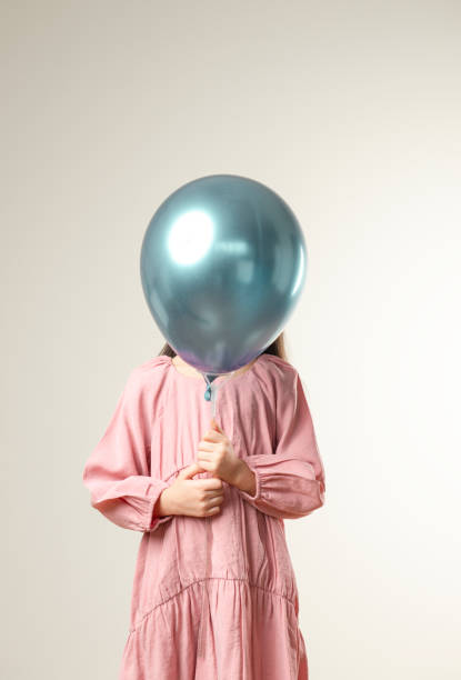 istock Girl Holding Balloon 1291083408