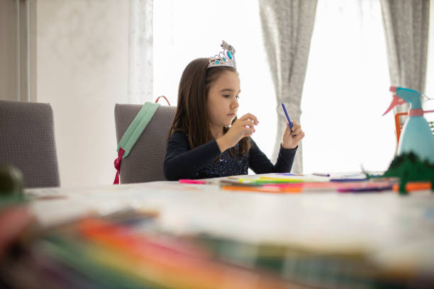istock Cute little girl studying at home 1291084444