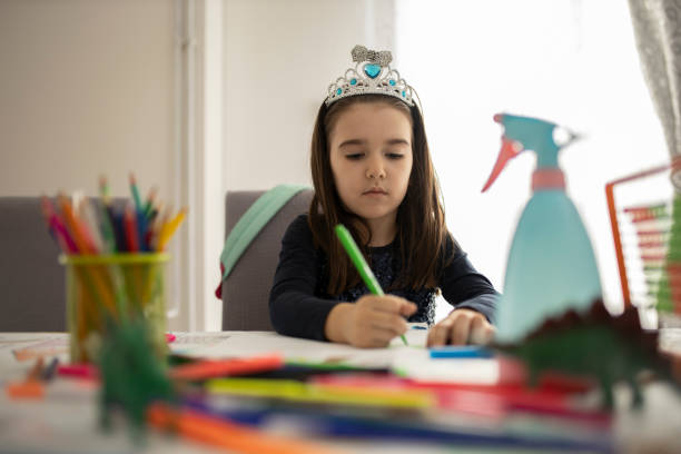 istock Cute little girl studying at home 1291084510