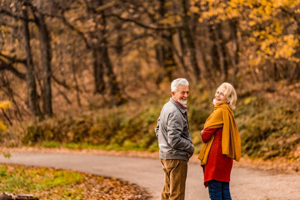 istock Senior couple walking together on a forest road. 1291086018