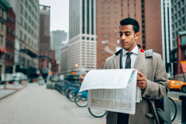 istock indian business man reading newspaper in manhattan 1291086396