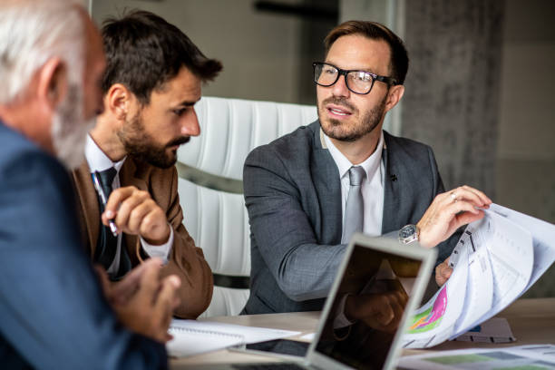 istock Young man showing his ideas to his colleagues. 1291087025