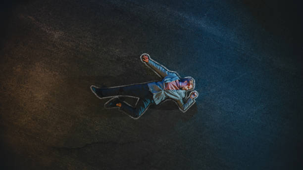 top down shot of a bloody man with chalk outline lying on the pavement after criminal accident on a street at night. young man was shot in head. concept of horrbile murder with death. - crime scene chalk outline crime murder imagens e fotografias de stock