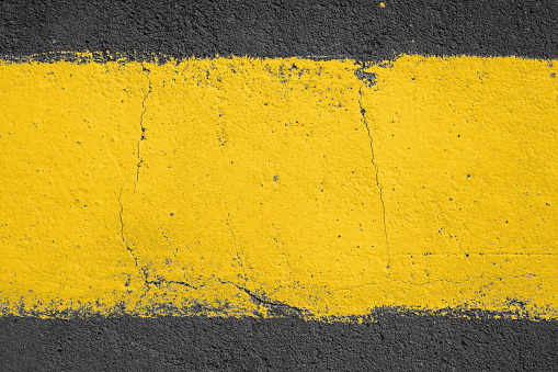 strip of yellow paint on the pavement. Use as frame or background