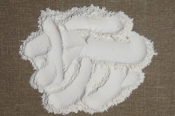 istock Flour on a background of linen fabric. Flour texture 1291089534