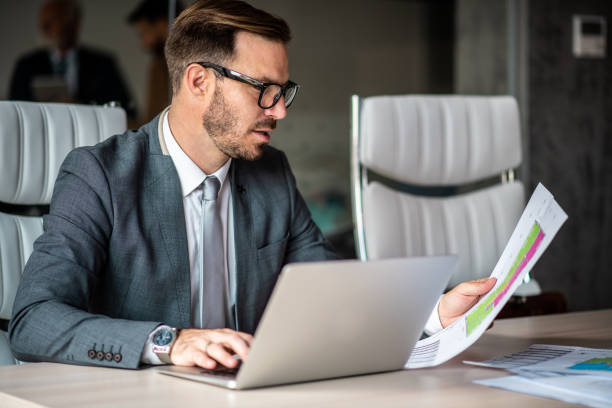 istock Junior businessman doing paperwork for job. 1291090779