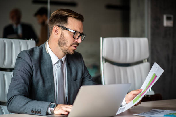 istock Young man concentrated on his paperwork. 1291090805