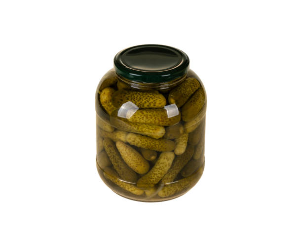 istock Jar of pickled gherkins isolated on white background with clipping path 1291090933